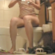 A woman sits down  on a toilet, lights a cigarette, takes a normal shit with a couple of plops, pees, and then has some spurts of gassy and gurgling diarrhea after pushing for a while.